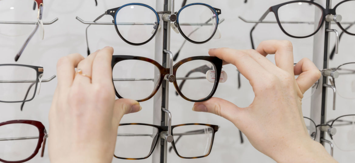 close-up-of-woman-hand-removing-eyeglasses-from-display